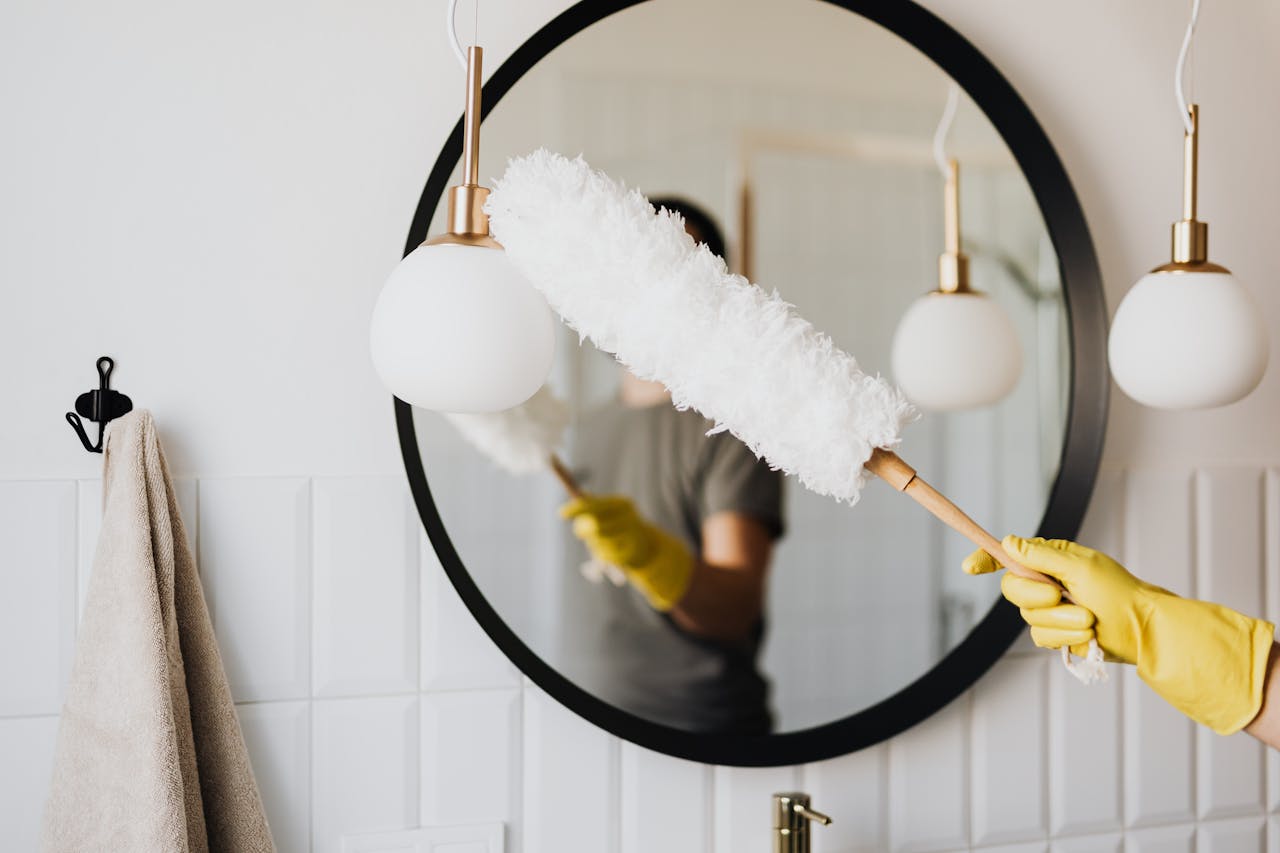 pexels-photo-4239031 Crop woman dusting lamp during housework